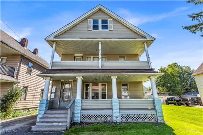 View of front of property featuring a front lawn and covered porch | Image 1