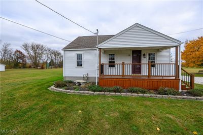 Bungalow-style home with a front yard and lovely landscaping | Image 2