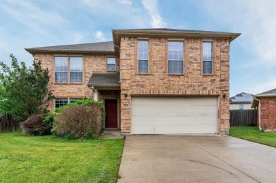 View of front of property with a garage and a front lawn | Image 1