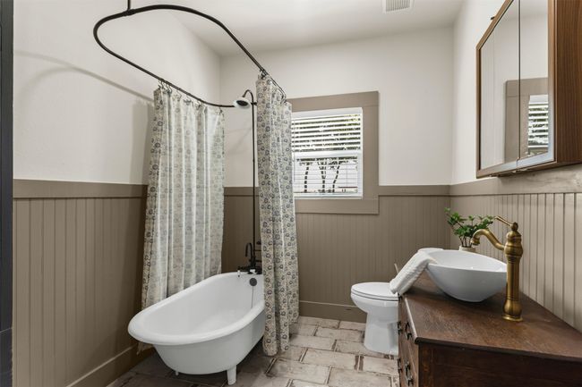 Full bathroom with wainscoting, vanity, and toilet | Image 29