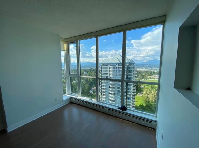 Unfurnished room featuring floor to ceiling windows, a healthy amount of sunlight, a city view, and a baseboard heating unit | Image 8