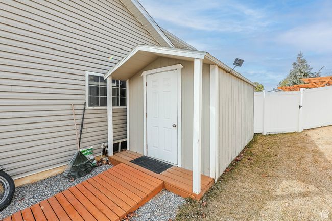 View of outdoor structure with fence and an outbuilding | Image 36