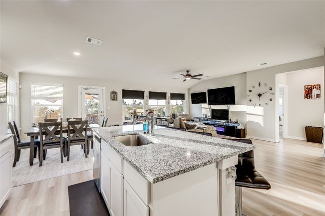 Kitchen with a sink, dishwasher, light wood-style floors, a ceiling fan, and recessed lighting | Image 9