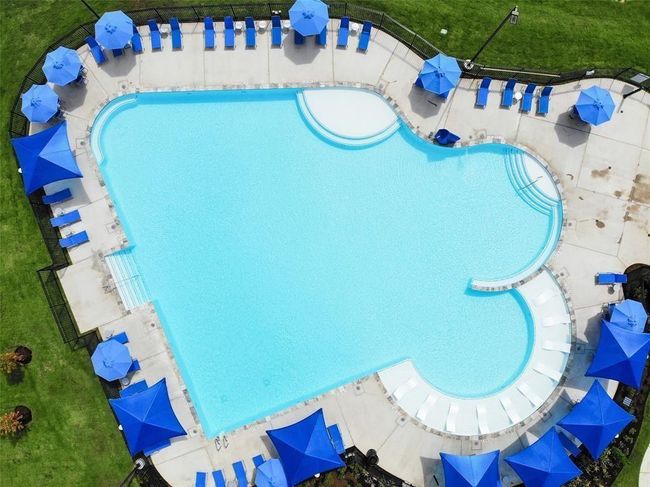 Comfortable lounge chairs line the water’s edge, with private cabanas offering shade and serenity. | Image 35