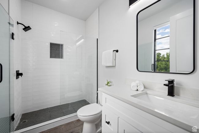 Bathroom featuring hardwood / wood-style floors, toilet, vanity, and an enclosed shower | Image 15
