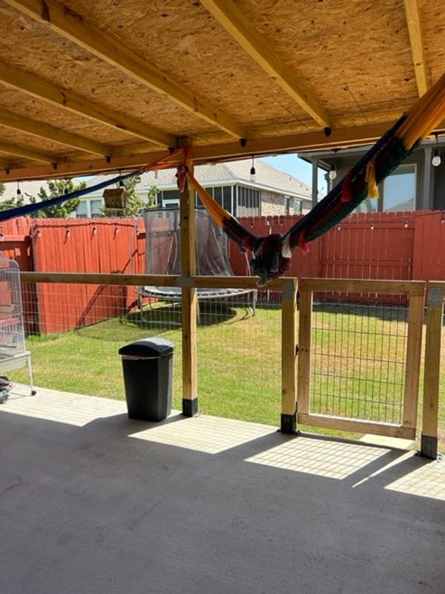 View of patio / terrace featuring a trampoline and fence | Image 9