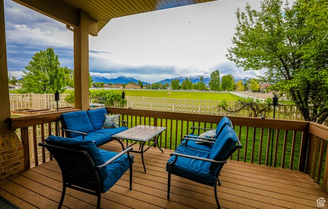 Wooden deck with a mountain view and outdoor lounge area | Image 45