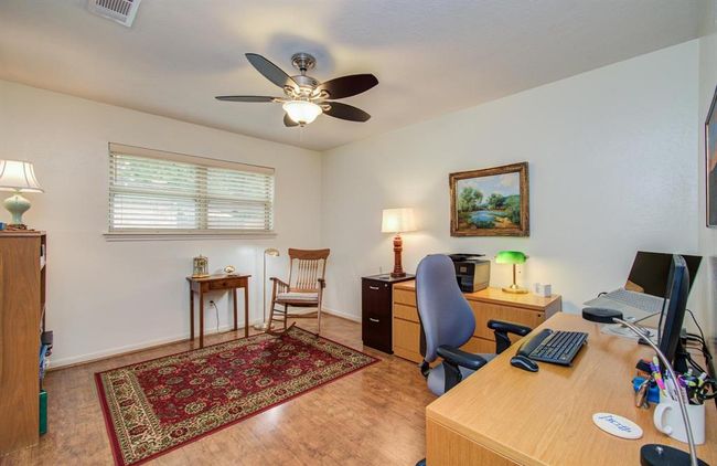 This secondary bedroom boasts wood floors. | Image 32