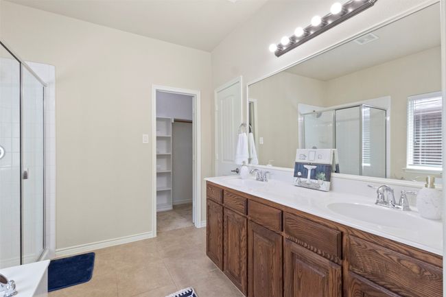 Full bathroom with a shower stall, double vanity, and tile patterned flooring | Image 14