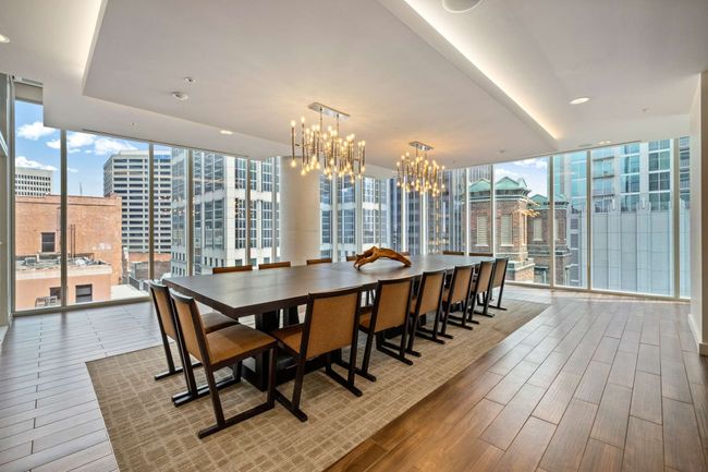 Sleek and sophisticated, this modern space draws in north and east-facing views of downtown, creating an elegant conference or dining room. | Image 48