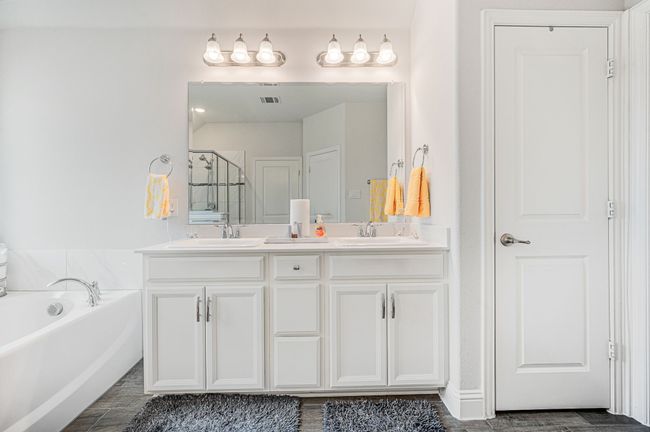 Ensuite bath with dual sinks, a garden tub, and linen closet | Image 24