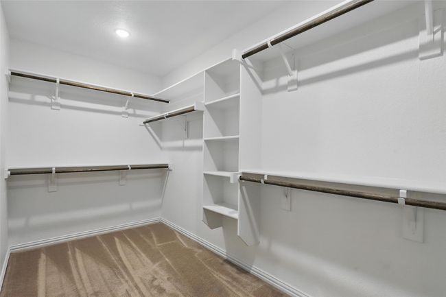 Walk in closet featuring carpet floors | Image 17