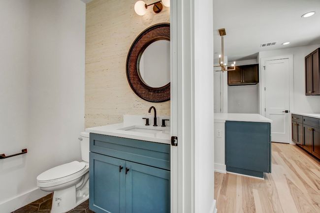 Bathroom featuring vanity, toilet, recessed lighting, a chandelier, and wood finished floors | Image 10