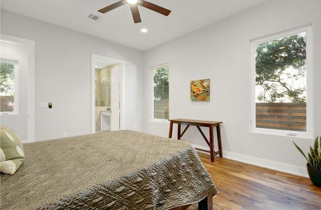 Bedroom featuring visible vents, wood finished floors, baseboards, ensuite bathroom, and recessed lighting | Image 15