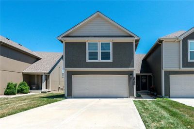 View of front of house featuring a garage and a front lawn | Image 2