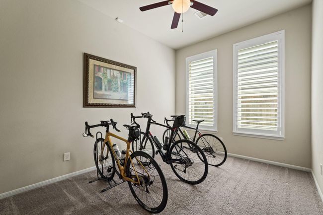 This room, with its bright windows, is a blank canvas for a serene bedroom, a game room, or a dynamic hobby space, ready for your personalized touch. | Image 11