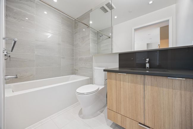 Full bath with vanity, toilet, visible vents, tile patterned flooring, and shower / washtub combination | Image 14