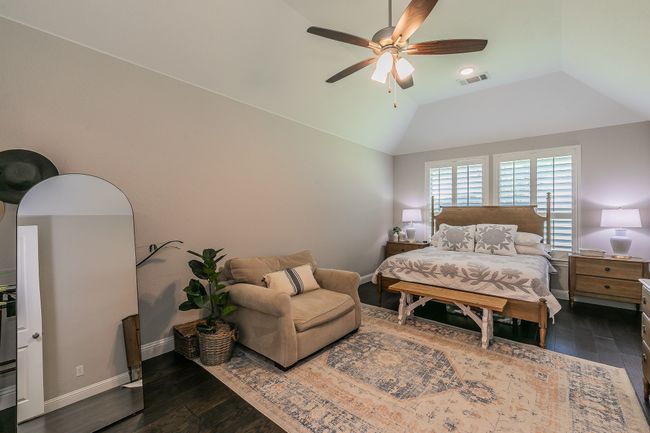 Bedroom with dark wood-type flooring, lofted ceiling, and ceiling fan | Image 16