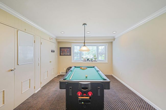 Game room featuring dark carpet, crown molding, pool table, and recessed lighting | Image 33