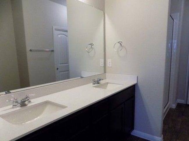 Full bath featuring double vanity and baseboards | Image 6