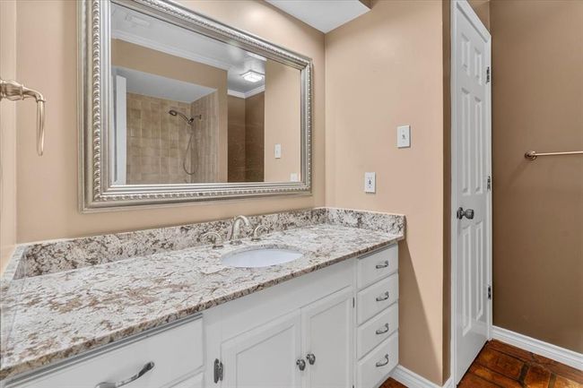 Bathroom with vanity, crown molding, and a tile shower | Image 28