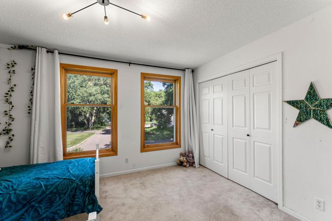 Two additional upper-level bedrooms are bright, inviting, and generously sized. | Image 16