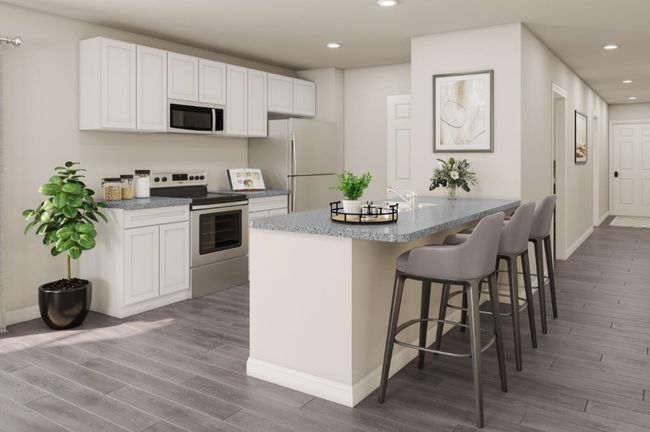 Kitchen with wood finished floors, white appliances, a kitchen bar, recessed lighting, and white cabinetry | Image 7