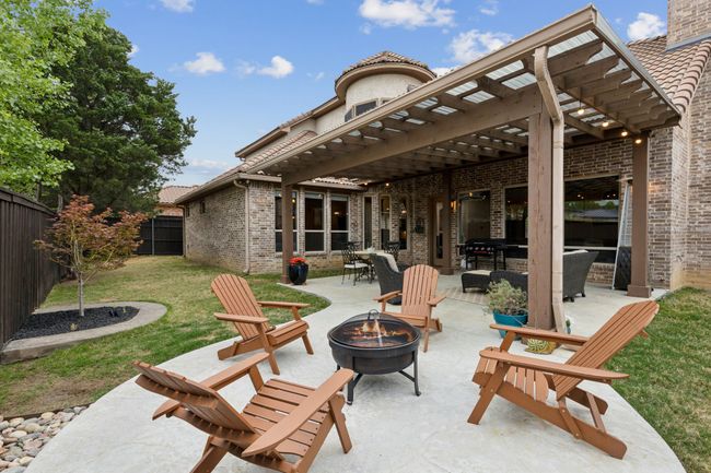 View of patio / terrace with a fenced backyard, a pergola, and an outdoor fire pit | Image 38