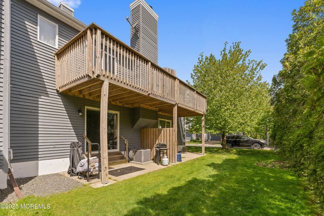Plentiful outdoor living space with covered patio and upper deck. Relax and enjoy nature or have a BBQ with friends and relatives after a beach day | Image 22
