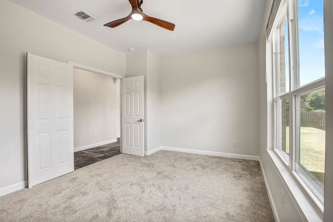 Downstairs office with ceiling fan and double doors | Image 21