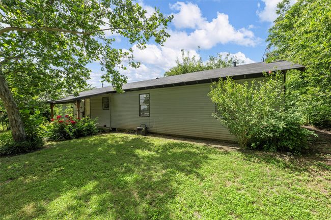 Rear view of house with a yard | Image 24