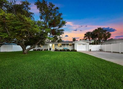 The property has a tremendous yard with lush vegetation. | Image 1