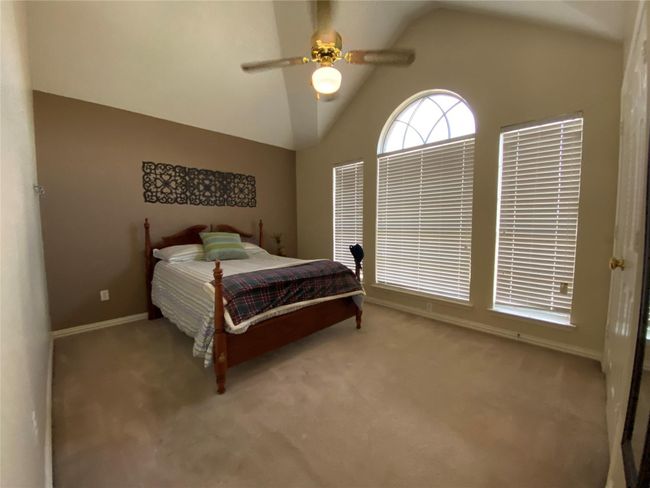 Bedroom featuring ceiling fan, lofted ceiling, and carpet floors | Image 28