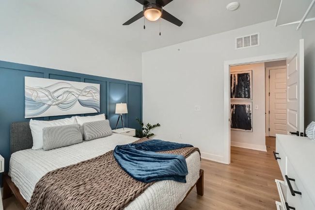 2nd Bedroom with light wood-type flooring, a wainscoted wall, a decorative wall, and ceiling fan | Image 22