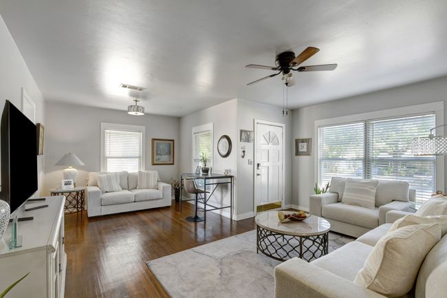Living room featuring dark hardwood / wood-style flooring, a wealth of natural light, and ceiling fan | Image 4