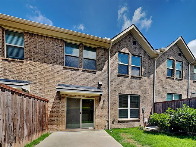 Back of house with fence, a patio, and brick siding | Image 14