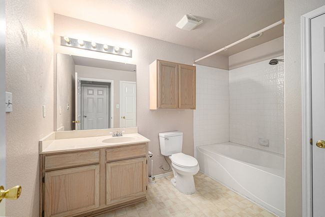 Full size bath is connected to hallway and to the 2nd primary bedroom. Built-in cabinets and Large linen closet. | Image 18