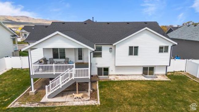 Rear view of property with stairway, a patio area, a fenced backyard, a porch, and a yard | Image 37