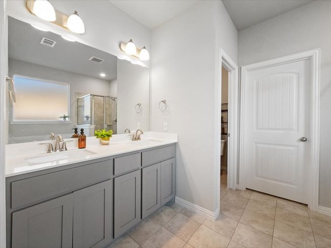 Bathroom featuring a sink, visible vents, and a stall shower | Image 17