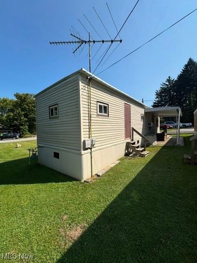 View of outbuilding featuring a lawn | Image 3