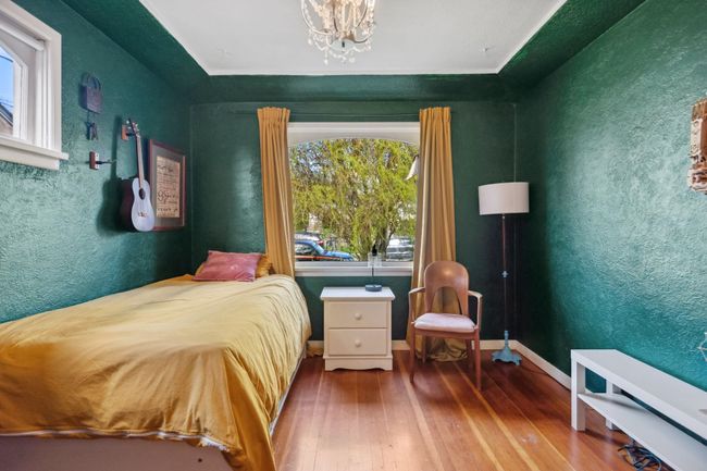 Bedroom featuring baseboards, a notable chandelier, and hardwood / wood-style flooring | Image 18