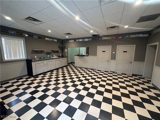 Kitchen featuring white cabinetry and a paneled ceiling | Image 11