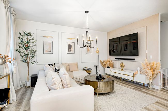 living room featuring an inviting chandelier and wood finished floors | Image 4