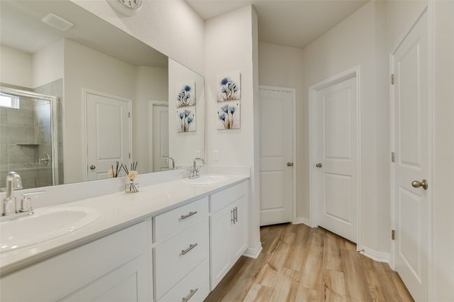 Bathroom with a stall shower, wood finished floors, and double vanity | Image 20