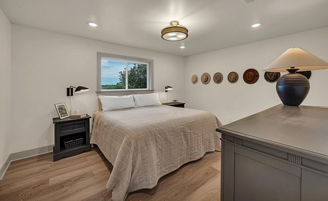 Primary Bedroom with light wood-type flooring and recessed lighting | Image 24