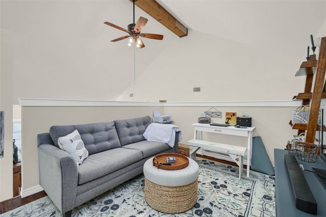 Living area featuring a ceiling fan and wood finished floors | Image 13