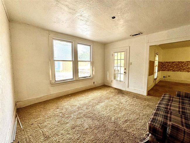 Dining room and living room each have an entry from the front porch | Image 14