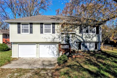 Split entry home with polymer siding, a garage and a front lawn | Image 1