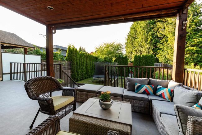Fenced backyard featuring an outdoor hangout area, a patio, and a trampoline | Image 23