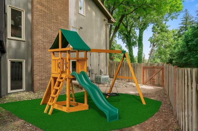Fenced backyard and generous side space that can feature a charming playset with slide and swings, set on fresh turf just outside the walkout lower level—perfect for outdoor fun and family living.(virtually staged) | Image 6